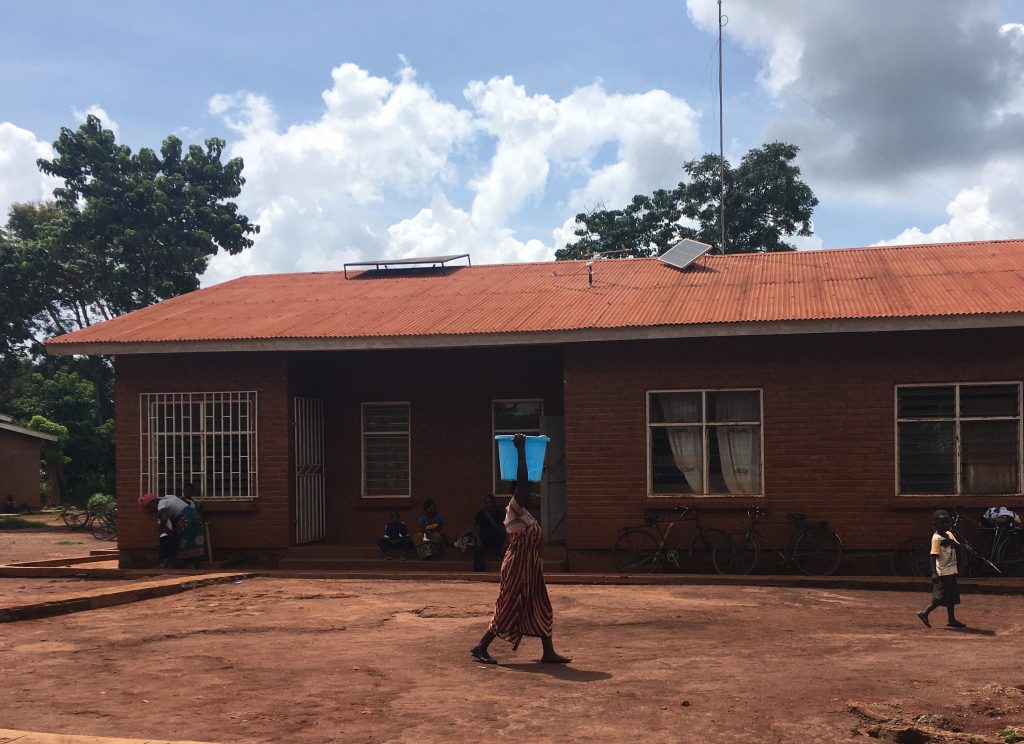 Two solar panels on the roof of a health clinic in Malawi